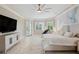 Spacious main bedroom with accent wall, large bed, flat screen television and access to backyard at 2280 Mackenzie Ct, Clearwater, FL 33765