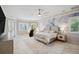 Spacious bedroom with decorative accent wall, ceiling fan, and a view of the backyard at 2280 Mackenzie Ct, Clearwater, FL 33765