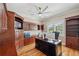 Spacious office features custom wood built-ins, desk, hardwood flooring, and plenty of natural light at 2280 Mackenzie Ct, Clearwater, FL 33765