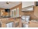 Well-equipped outdoor kitchen with stainless steel appliances and a built-in grill under a covered patio at 2280 Mackenzie Ct, Clearwater, FL 33765