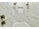 Elegant walk-in shower features dual shower heads, marble tile walls and floor, and a toiletry shelf at 2280 Mackenzie Ct, Clearwater, FL 33765