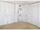 Bright bedroom featuring a wall of closets and a doorway leading to an adjacent room at 24862 Us Highway 19 N # 2801, Clearwater, FL 33763