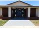 Front of clubhouse featuring brick columns and a double door entryway at 24862 Us Highway 19 N # 2801, Clearwater, FL 33763