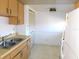 Functional kitchen with wood cabinets, a white refrigerator, and a double stainless steel sink at 24862 Us Highway 19 N # 2801, Clearwater, FL 33763