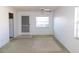 Bright living room with neutral carpeting, a screen door, and two large windows at 24862 Us Highway 19 N # 2801, Clearwater, FL 33763
