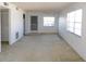 Bright living room featuring neutral carpeting, a ceiling fan, and two large windows at 24862 Us Highway 19 N # 2801, Clearwater, FL 33763