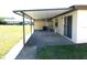 View of a covered patio featuring sliding glass doors and a fenced enclosure at 24862 Us Highway 19 N # 2801, Clearwater, FL 33763
