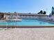 Community pool with lounge chairs and a clear blue swimming pool at 24862 Us Highway 19 N # 2801, Clearwater, FL 33763