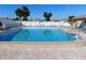 Community pool surrounded by lounge chairs and a clear blue swimming pool at 24862 Us Highway 19 N # 2801, Clearwater, FL 33763