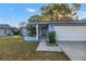 View of entrance featuring covered front porch that leads to a single car garage at 2552 Bramblewood W Dr, Clearwater, FL 33763