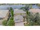 Lovely two-story home with tile roof, lush greenery, and a serene lake view at 2665 Lakebreeze N Ln, Clearwater, FL 33759