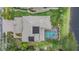 Aerial shot of the house showcasing the screened-in pool, patio, and lush landscaping at 2665 Lakebreeze N Ln, Clearwater, FL 33759