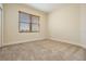 Bright bedroom featuring a window with wood blinds and neutral carpeting at 2665 Lakebreeze N Ln, Clearwater, FL 33759