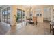 Cozy dining area with backyard pool view, stylish light fixture, and seating for four at 2665 Lakebreeze N Ln, Clearwater, FL 33759