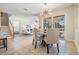 Bright dining area with sliding glass doors and backyard pool view, stylish light fixture at 2665 Lakebreeze N Ln, Clearwater, FL 33759