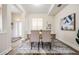 Bright dining room with modern floors, stylish rug and furniture, adjacent to foyer at 2665 Lakebreeze N Ln, Clearwater, FL 33759
