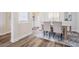 Bright dining room with modern floors, stylish rug and furniture, adjacent to foyer at 2665 Lakebreeze N Ln, Clearwater, FL 33759