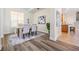 Bright dining room features modern decor, wood flooring, and a view into the kitchen at 2665 Lakebreeze N Ln, Clearwater, FL 33759