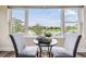 This intimate eating area has water views at 2665 Lakebreeze N Ln, Clearwater, FL 33759
