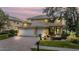 Charming two-story home with a three-car garage, manicured landscaping, and inviting entrance at 2665 Lakebreeze N Ln, Clearwater, FL 33759