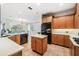 Spacious kitchen features a center island, stainless steel appliances, and an adjacent dining area at 2665 Lakebreeze N Ln, Clearwater, FL 33759