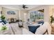 Bright living room with comfortable seating and a view of the screened-in patio and pool area at 2665 Lakebreeze N Ln, Clearwater, FL 33759