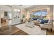 Sunlit living room with neutral tones, comfortable seating, and large windows overlooking the outdoors at 2665 Lakebreeze N Ln, Clearwater, FL 33759