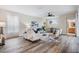 Comfortable living room featuring modern decor, neutral tones, and wood flooring at 2665 Lakebreeze N Ln, Clearwater, FL 33759
