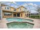 Relaxing screened-in pool and spa area with brick pavers and lush backyard at 2665 Lakebreeze N Ln, Clearwater, FL 33759