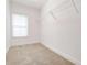 Empty walk-in closet with carpet, shelving and one window at 2665 Lakebreeze N Ln, Clearwater, FL 33759