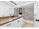 Bathroom featuring granite countertops, undermount sink, and walk-in shower with decorative tile at 269 Algiers Dr, Venice, FL 34293