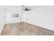 Bright, empty bedroom features tile floors, large window, and a ceiling fan at 269 Algiers Dr, Venice, FL 34293