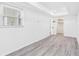 Bright and modern bedroom featuring light wood floors, a large window, and ample closet space at 269 Algiers Dr, Venice, FL 34293