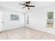 Bright bedroom with tile flooring, ceiling fan, and plenty of natural light from three windows at 269 Algiers Dr, Venice, FL 34293
