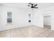 Well-lit bedroom featuring tile flooring, a ceiling fan, and two windows that provide natural light at 269 Algiers Dr, Venice, FL 34293