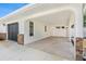 Attached carport featuring textured concrete floor and white painted arches and supports at 269 Algiers Dr, Venice, FL 34293