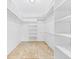 Bright closet featuring built-in shelving and rod providing ample storage space at 269 Algiers Dr, Venice, FL 34293