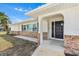 Charming front entrance with a decorative brick facade and an arched entryway, creating an inviting curb appeal at 269 Algiers Dr, Venice, FL 34293