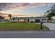 Charming single-story home with a well-manicured lawn and a classic brick accent wall at 269 Algiers Dr, Venice, FL 34293