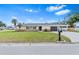 Charming single-story home with a well-manicured lawn and a classic brick accent wall at 269 Algiers Dr, Venice, FL 34293
