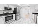 Bright kitchen with stainless steel appliances, white cabinets, and black countertop at 269 Algiers Dr, Venice, FL 34293