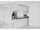 Kitchen with black countertop and breakfast bar that opens to the living area at 269 Algiers Dr, Venice, FL 34293