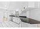 White kitchen featuring stainless steel appliances, black countertops, and an undermount sink at 269 Algiers Dr, Venice, FL 34293