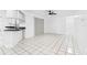 Open-concept living room with tile flooring and a view of the kitchen and adjacent rooms at 269 Algiers Dr, Venice, FL 34293