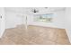 Bright and open living room with tile flooring, a large window, and minimalist design, providing a versatile space at 269 Algiers Dr, Venice, FL 34293