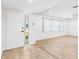 Bright living room with tiled floors, a large window, and a modern front door, creating a clean and airy space at 269 Algiers Dr, Venice, FL 34293