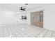 Spacious living room with tile floors, a ceiling fan and connection to the kitchen area at 269 Algiers Dr, Venice, FL 34293
