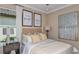 Comfortable bedroom with a queen bed, decorative artwork, and cozy lighting at 29845 Imperati Blvd, Wesley Chapel, FL 33543