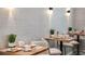 Cozy dining area features tables with breakfast items and coffee, complemented by modern lighting at 29845 Imperati Blvd, Wesley Chapel, FL 33543