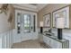 Inviting entryway with a decorative door, wainscoting, console table and luxury accents at 29845 Imperati Blvd, Wesley Chapel, FL 33543